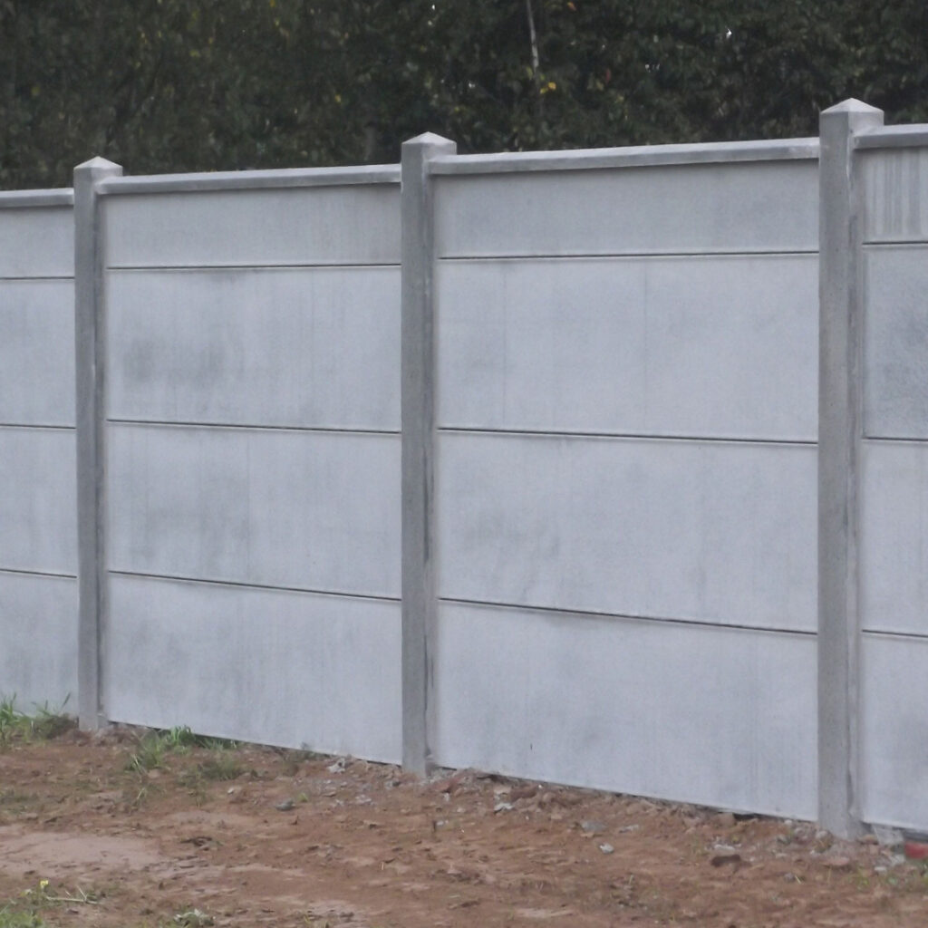 Clôture en panneaux de béton gris avec poteaux intermédiaires, installée en limite de terrain.