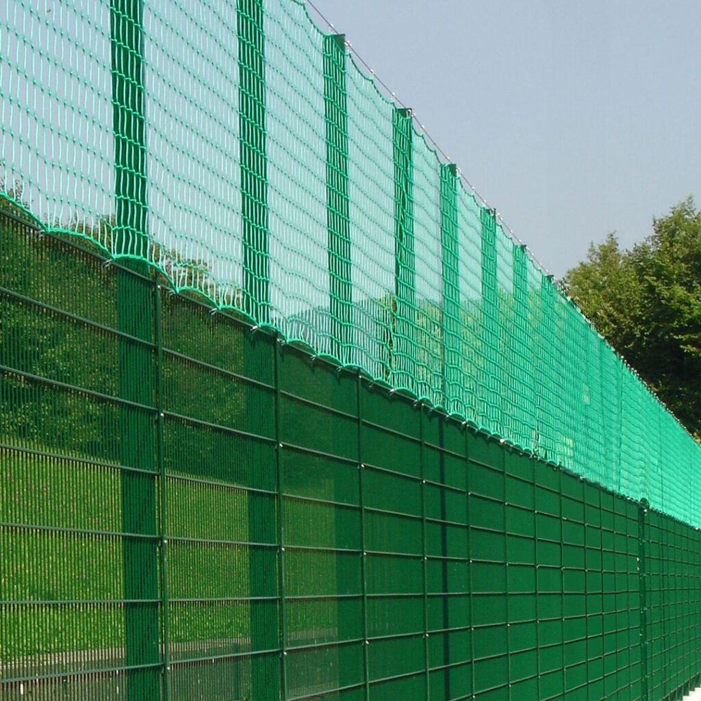 Clôture grillagée pour terrain de sport avec filet pare-ballons.