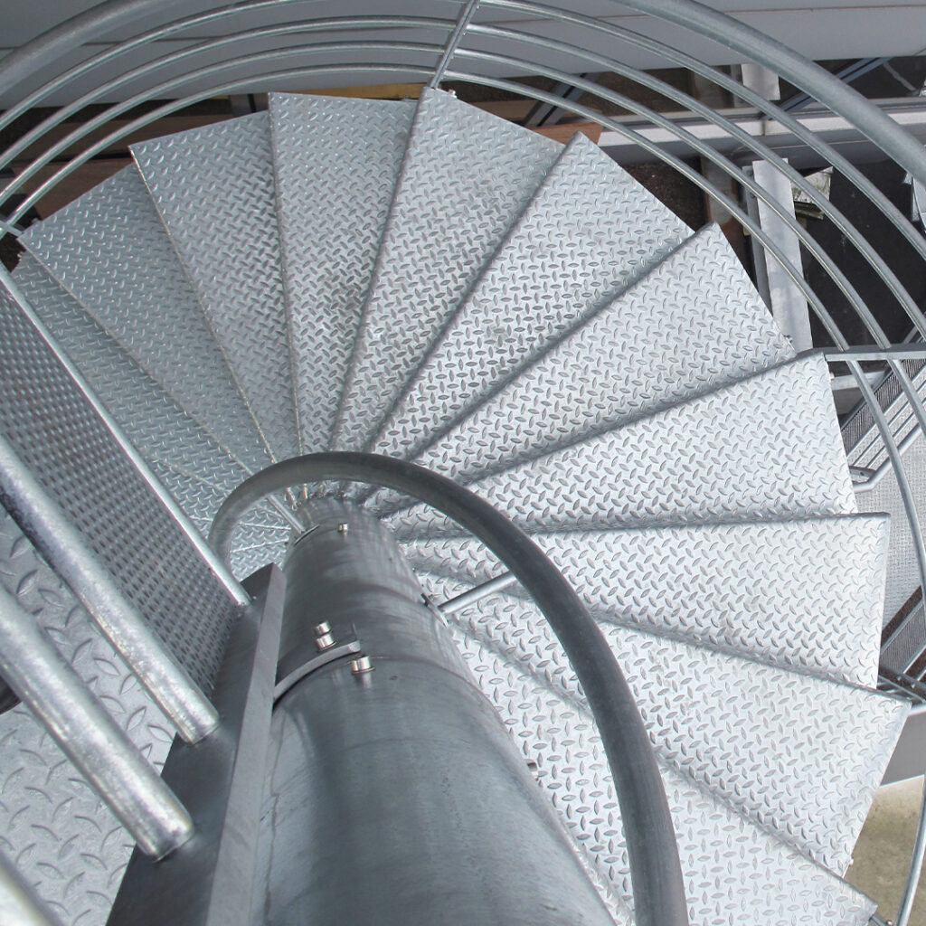 Escalier de secours hélicoïdal en acier galvanisé avec marches antidérapantes.